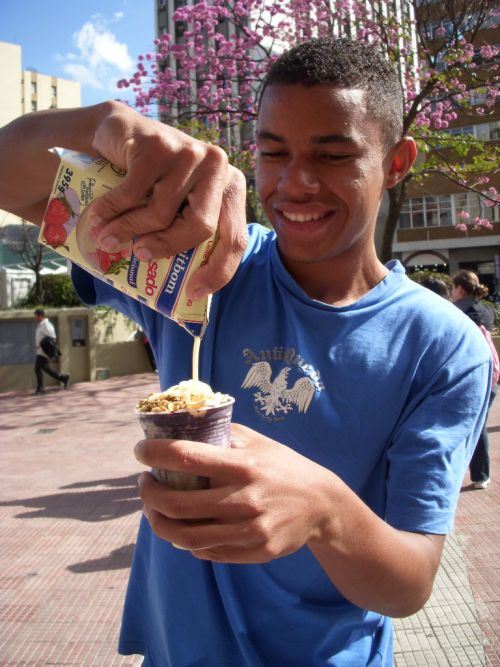 コンデンスミルクがかけられるアサイのアイスクリーム