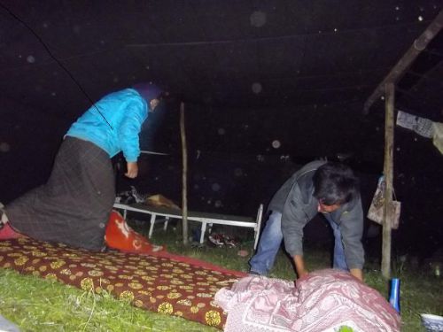 夜寝る準備。草の上に布団を敷いて寝る。民族衣装をかぶれば寒くない