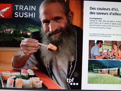 これが「寿司列車」の広告。スイスの牧歌的風景をエンジョイしながら寿司を食べよう！というコンセプトなのでしょうか
