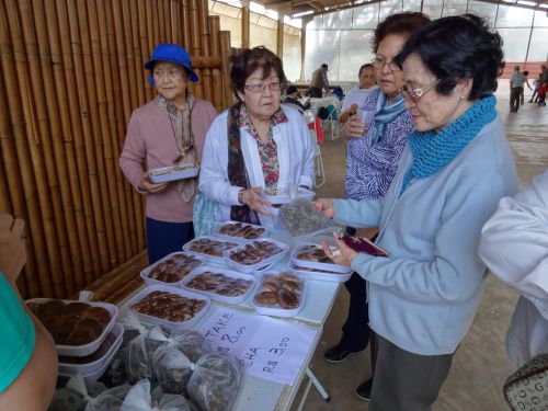 訪問先でしいたけを購入する日本人（1世、2世）の年配の女性たち